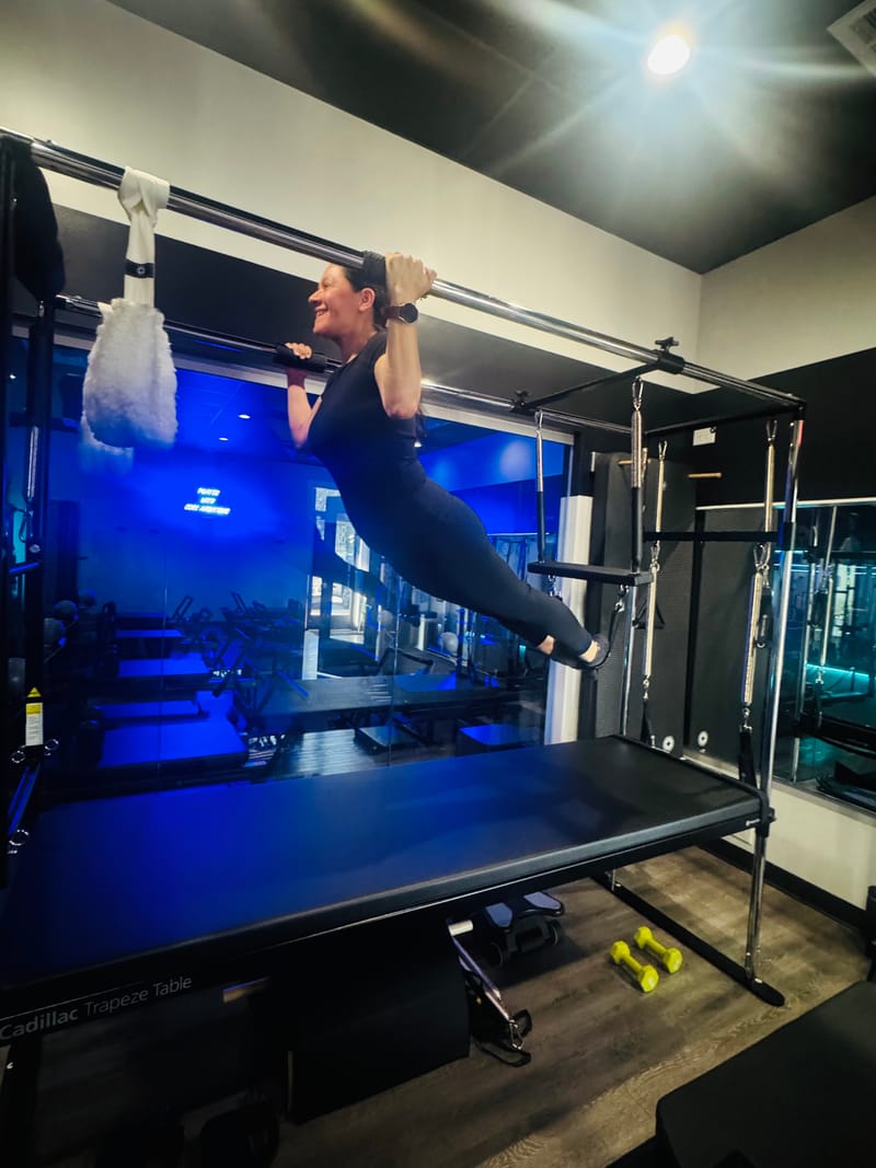 Pull-up on the Cadillac push-through bar during private training at Core Ambitions